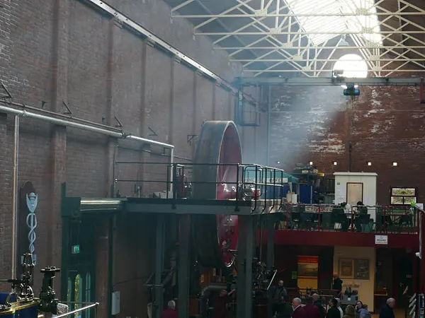 Restored mill engines and flywheels inside the brick engine hall of Bolton Steam Museum