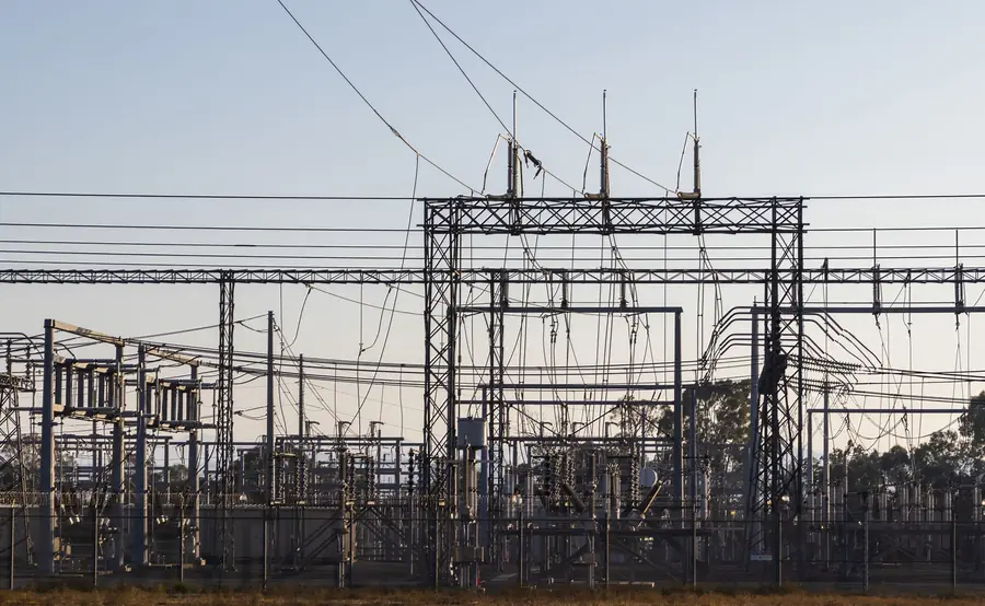 Electricity substation with switchgear and overhead lines under a pale sky, where a commercial solar G99 connection is assessed