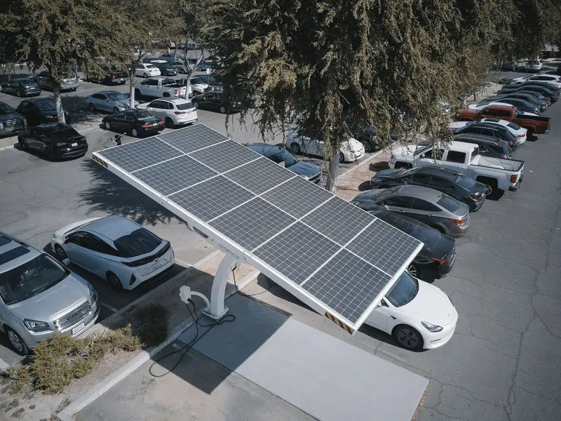 Aerial view of a staff car park with solar carport canopies over two rows of parking bays