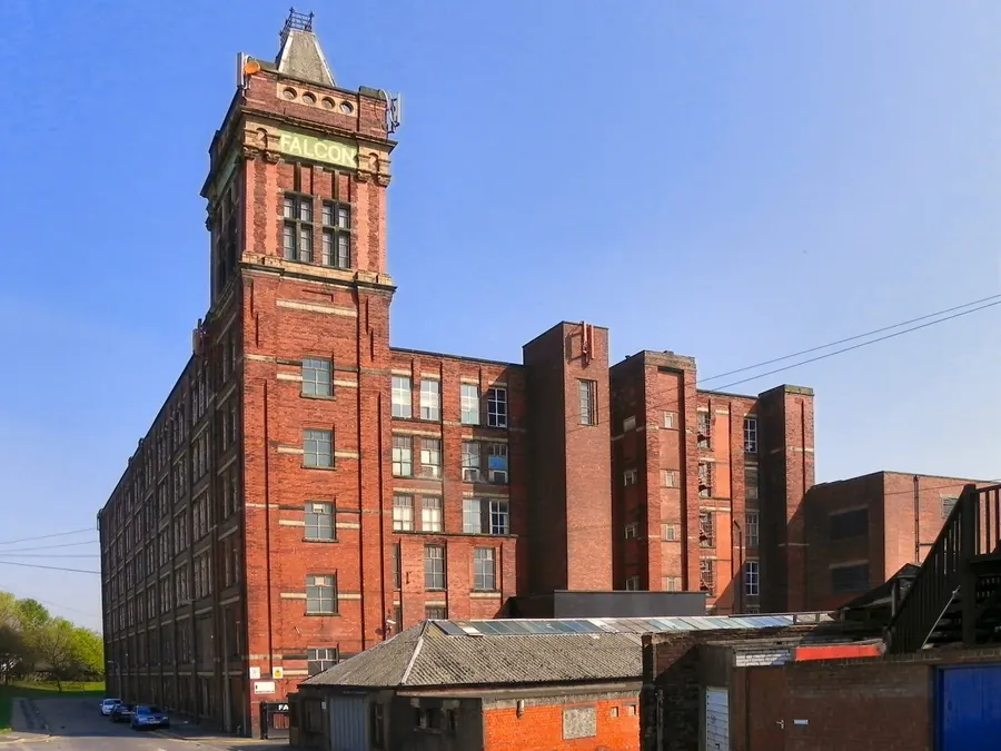 Falcon Mill, a tall red-brick former cotton spinning mill with corner tower in Halliwell, Bolton