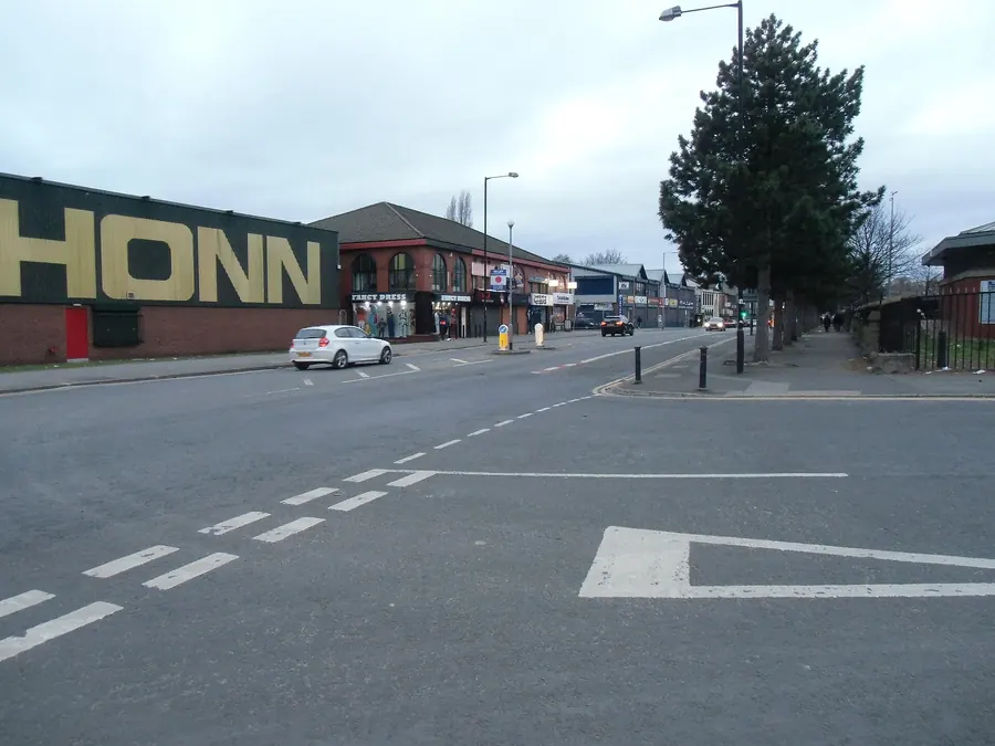 Wholesale and cash-and-carry premises lining a wide street in Strangeways, Cheetham