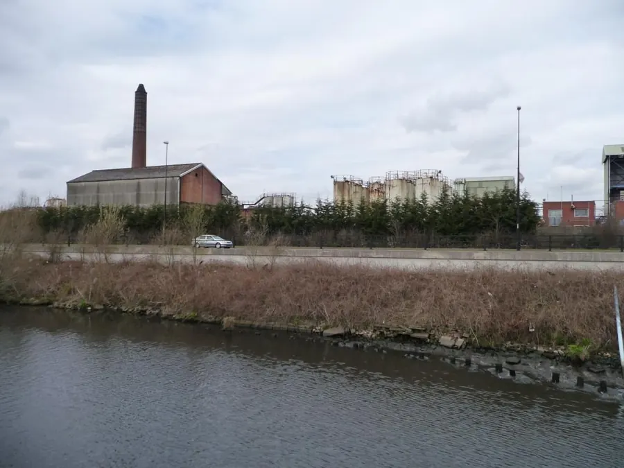 Canal-side industrial buildings and a brick chimney at Cadishead, Salford